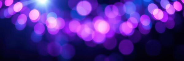 Vibrant purple bokeh lights create a festive atmosphere during an evening celebration or event photo