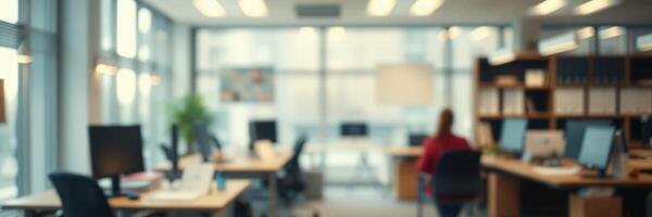 Office environment featuring workstations and a person engaged in tasks during daylight hours photo