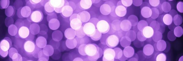 Beautiful purple bokeh lights creating a dreamy atmosphere at a festive event during the evening hours photo