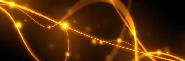 Bright and fluid golden light strands weaving through a dark background in an abstract display of movement and energy photo