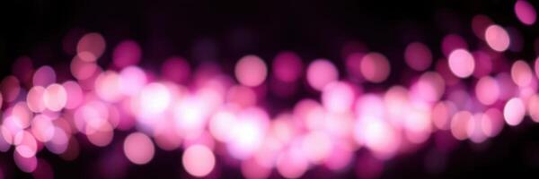 Vibrant pink bokeh lights creating a dreamy atmosphere during a nighttime event photo