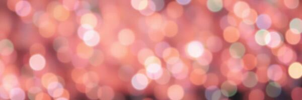 Beautiful bokeh background with soft pink and orange lights creating a dreamy atmosphere for celebrations and events photo