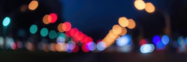 Nighttime city street illuminated by colorful bokeh lights creates a vibrant urban atmosphere photo