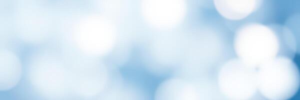 Soft blue bokeh background creates a serene and calming atmosphere for various design uses photo