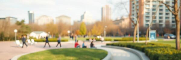 People enjoying a sunny day in a city park with green spaces and modern buildings in the background photo