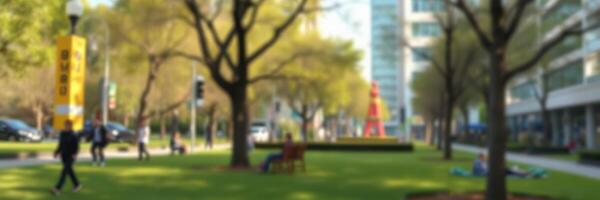 People enjoying a sunny day in a city park surrounded by modern buildings and green trees photo