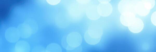 Soft blue bokeh lights create a dreamy atmosphere in a calm evening setting by the water photo