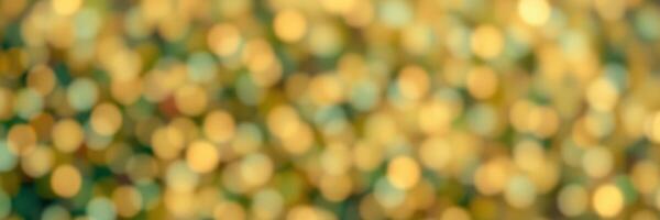 Sparkling golden lights create a shimmering effect in a blurred background setting during an evening event photo