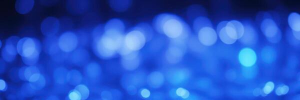 Magical blue bokeh lights create a serene atmosphere in a dimly lit space during evening hours photo