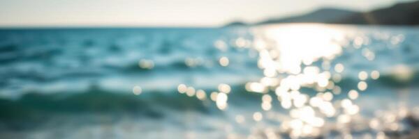 Bright sunlight reflects off gentle ocean waves during a serene day at the beach photo