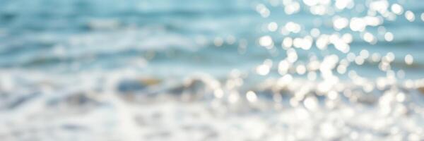 Gentle waves sparkle under sunlight at a tranquil beach in the afternoon photo