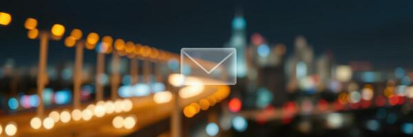 Nighttime cityscape with blurred lights highlighting urban activity and a digital envelope symbol photo