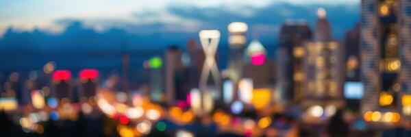 Colorful city lights illuminate the skyline at dusk with blurred outlines of buildings and vibrant signage photo