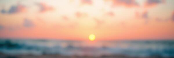 Vibrant sunset over the ocean with soft waves and colorful clouds at a serene seaside location photo