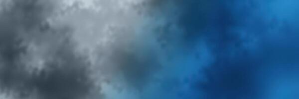 Clouds shift in various shades of blue and gray during a late afternoon sky transition over a serene landscape photo
