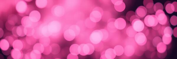Soft pink bokeh lights create a dreamy atmosphere at a nighttime event in a vibrant urban setting photo