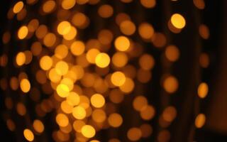 Warm glowing bokeh lights create a festive atmosphere during a nighttime celebration photo