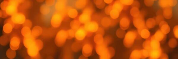 Vibrant orange bokeh lights create a warm atmosphere during an evening gathering photo