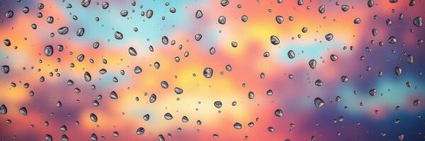 Colorful sunset with raindrops on window reflecting vibrant hues in the sky photo