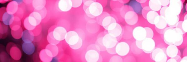 Vibrant bokeh lights create a festive atmosphere in a soft pink tone for an evening event photo