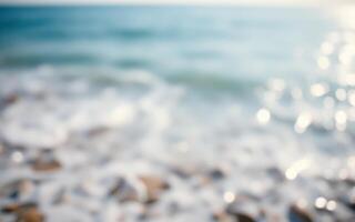 Calm waves gently lap at the shore under bright sunlight on a serene day at the beach photo