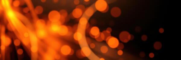 Bright orange sparks dance in the air against a dark background, creating a mesmerizing visual display during an evening bonfire photo