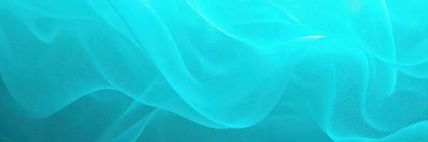Swirling turquoise fabric floating softly in the water during a sunny afternoon at a tranquil location photo