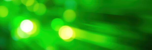 Vibrant green light reflections create an abstract visual experience in a dynamic environment during nighttime festivities photo