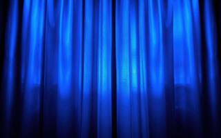 Beautiful blue curtains elegantly flowing in soft light at a theater venue during a performance photo
