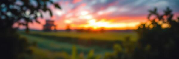Beautiful sunset over a serene landscape with vibrant colors and soft clouds photo