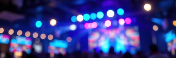 Vibrant concert atmosphere filled with colorful lights and an engaged audience enjoying live music in a crowded venue photo