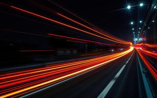 Nighttime cityscape with streaks of light from moving vehicles on a busy road photo