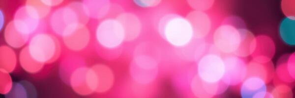Bright pink bokeh lights create a festive and vibrant atmosphere at a nighttime celebration or event photo