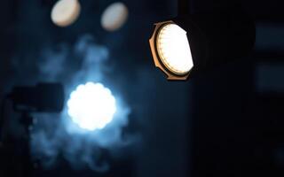 Dramatic lighting contrasts create an atmospheric effect in a darkened space during a performance or event photo