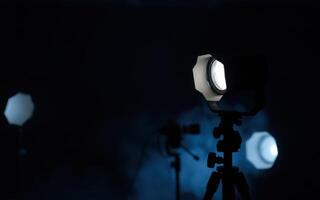 Lighting equipment setup for a professional photography session in a dark studio environment photo
