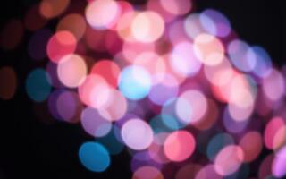 Colorful bokeh lights create a vibrant atmosphere in a nighttime celebration during summer festivities photo
