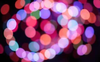 Colorful bokeh lights create a festive atmosphere during an evening celebration in a city park photo
