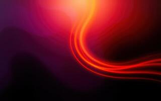 Vibrant abstract swirl of red and orange colors flows smoothly against a dark background photo