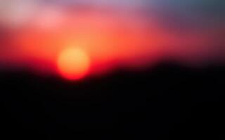 Vibrant sunset casts hues of orange and pink over a serene landscape photo