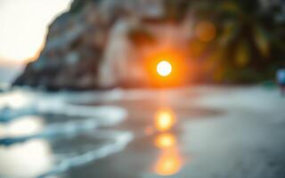 Vibrant sunset over the beach with soft waves gently lapping at the shore in a tropical paradise photo