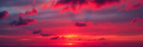 Captivating sunset with vibrant red and purple hues over the ocean horizon during twilight photo