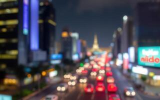 City skyline with blurred traffic lights and illuminated buildings at night photo