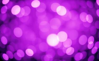 Colorful bokeh lights create a vibrant purple atmosphere at a lively event or celebration at night photo