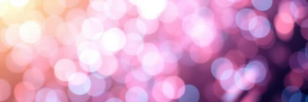 Beautiful bokeh lights create a dreamy atmosphere in soft pink and purple hues during a festive evening celebration photo