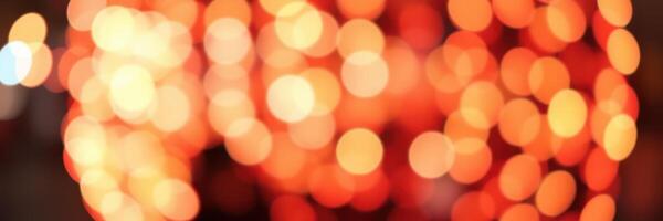 Warm orange bokeh lights create a festive atmosphere during a celebratory evening event in the city photo