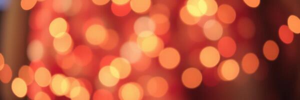 Orange and yellow bokeh lights create a warm atmosphere for a festive celebration in an indoor setting during evening hours photo