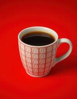 Stylish ceramic coffee cup filled with dark brew on bright red background photo
