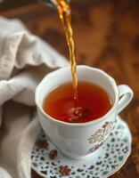 Pouring hot tea into a delicate cup on a wooden table creates a calming atmosphere for tea lovers photo