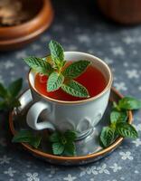 Fresh mint tea served in a white cup with a garnish of mint leaves on a textured background photo
