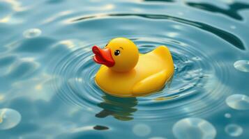 Bright yellow rubber duck floating on calm water in a serene setting photo